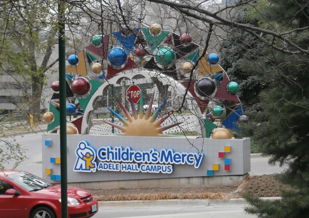 Children's Mercy Adele Hall Campus sign with colorful holiday ornament display outdoors
