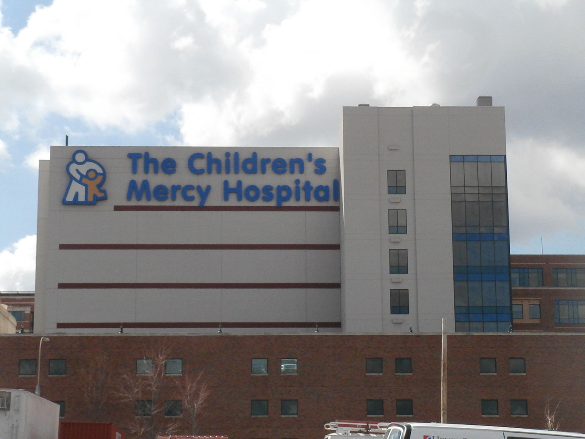 The Children's Mercy Hospital building with blue signage and a cloudy sky
