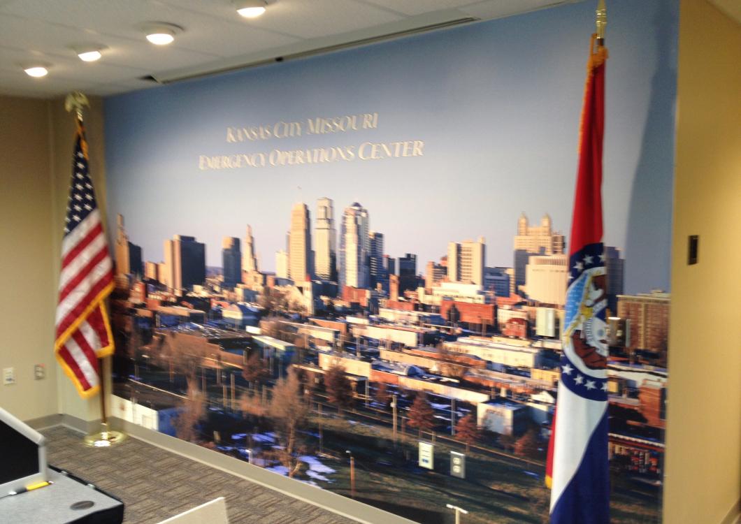 Wall mural of a city skyline with U.S. and Ohio flags in a government office lobby