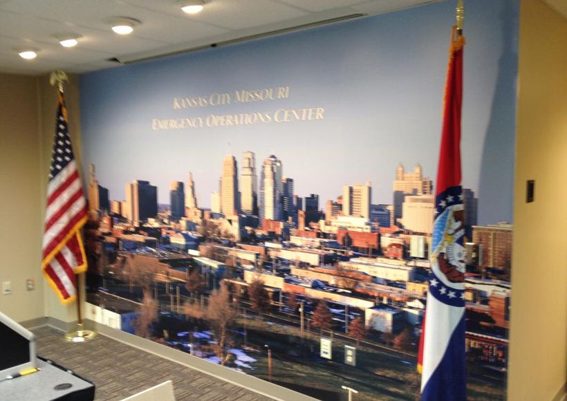 Wall mural of a city skyline with U.S. and state flags in an office lobby