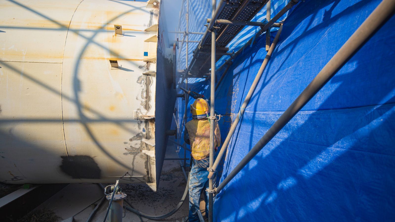 Commercial Painter Spray Painting Metal Building