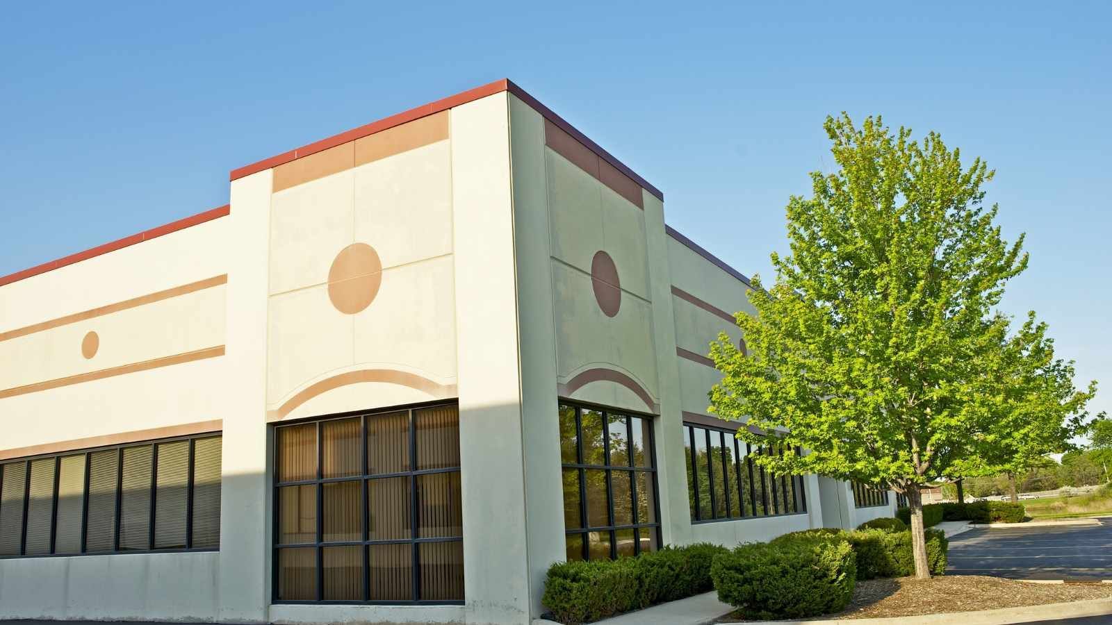 exterior painting in all seasons large commercial building with white and red exterior paint