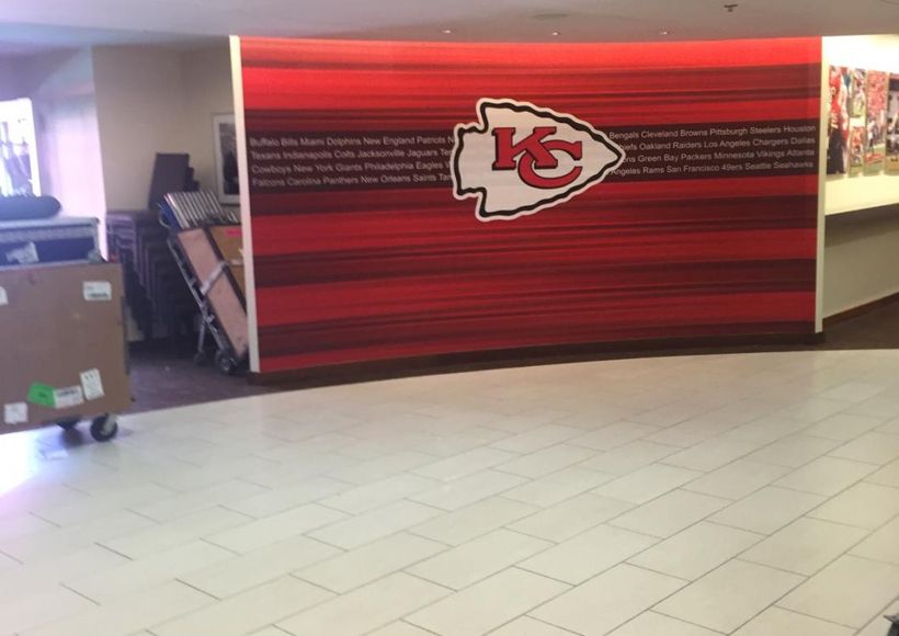 Kansas City Chiefs kiosk with red wall display in a lobby area