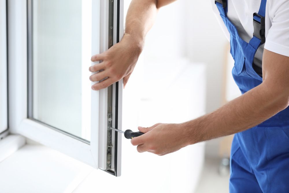 Repairing A Glass Window With A Screwdriver — Ezi Slide - Glass, Sliding, Track & Security Doors Repair in Gold Coast, QLD