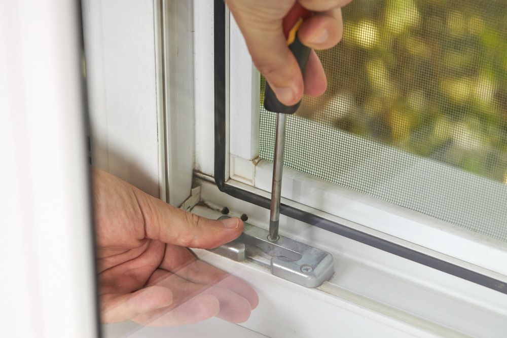 Fixing A Window With A Screwdriver — Ezi Slide - Glass, Sliding, Track & Security Doors Repair in Ashmore, QLD