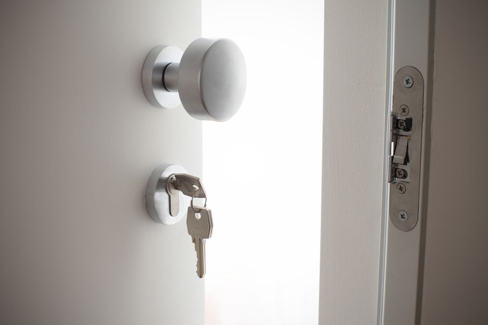 A Close Up Of A Door With A Key In The Lock — Ezi Slide - Glass, Sliding, Track & Security Doors Repair in Gold Coast, QLD