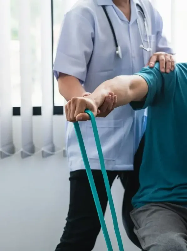 A nurse is helping a patient with a resistance band