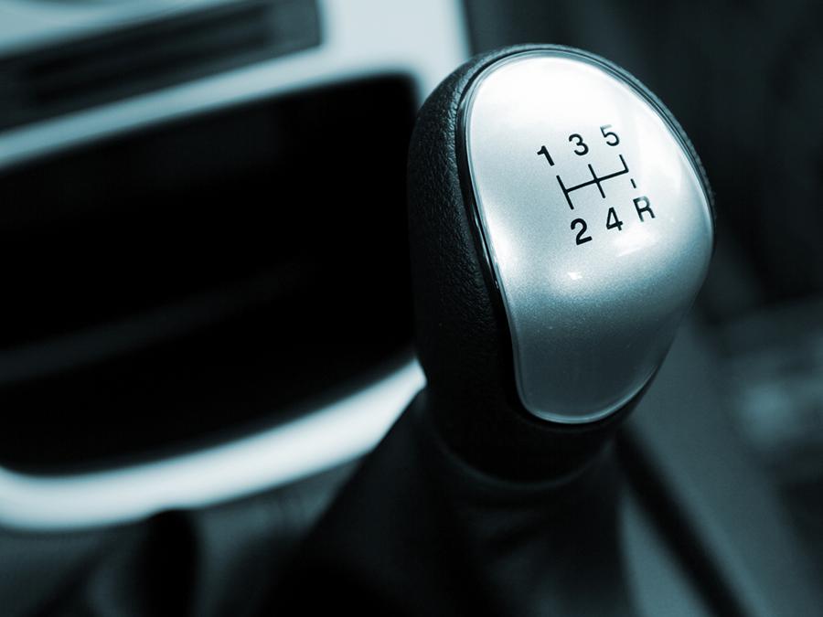 A close up of a car shifter with the number 135 on it