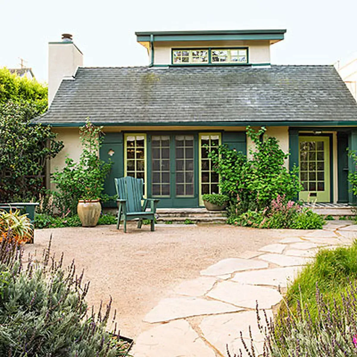 Charming cottage with green shutters.
