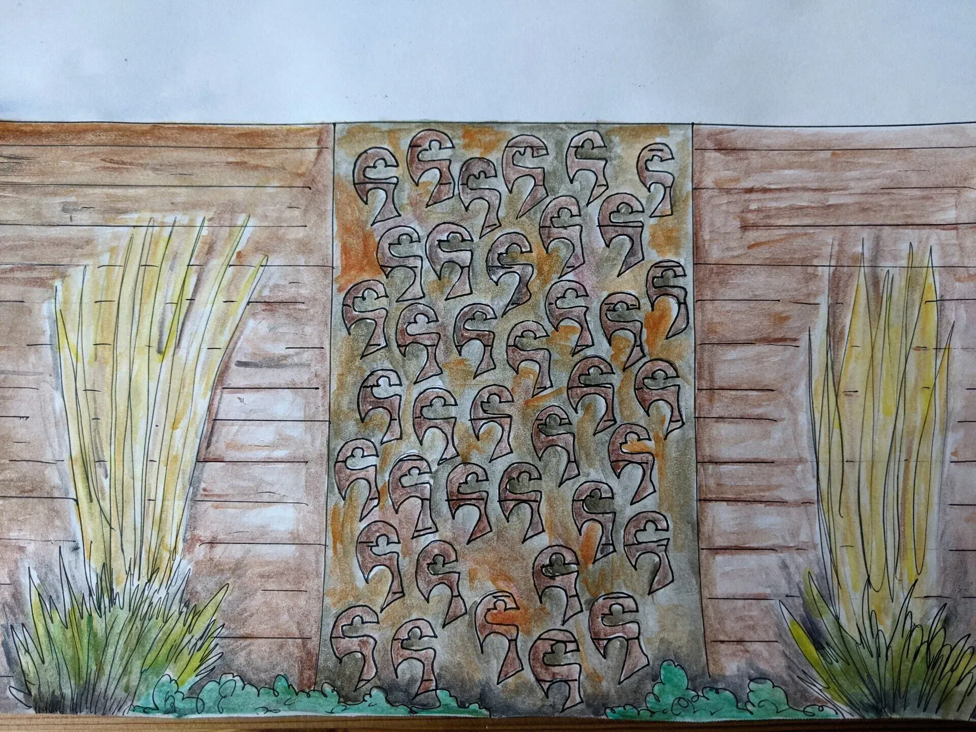 A wall with multiple carved faces surrounded by beige, gold, and brown plants, set against a wooden background.