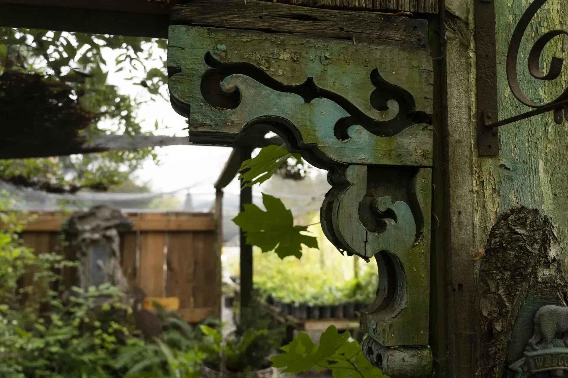 Close-up of a weathered, ornately carved wooden architectural detail.