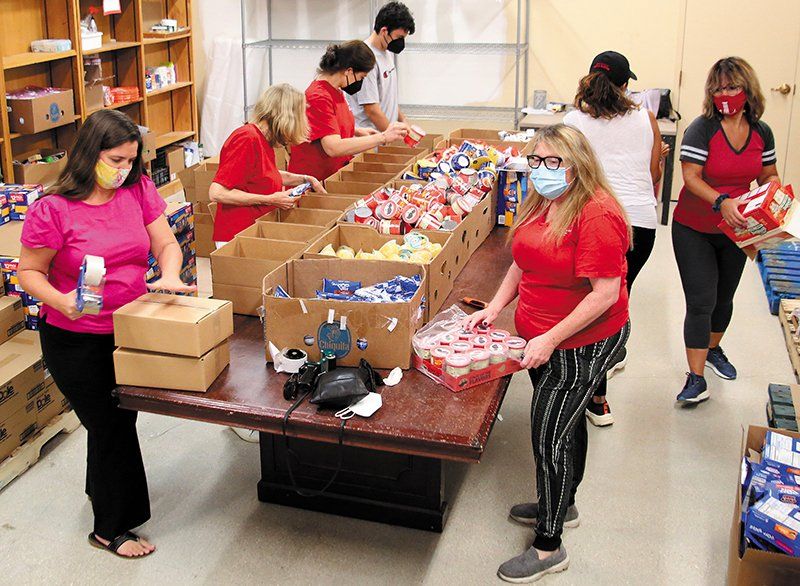 Volunteers boxing up food.