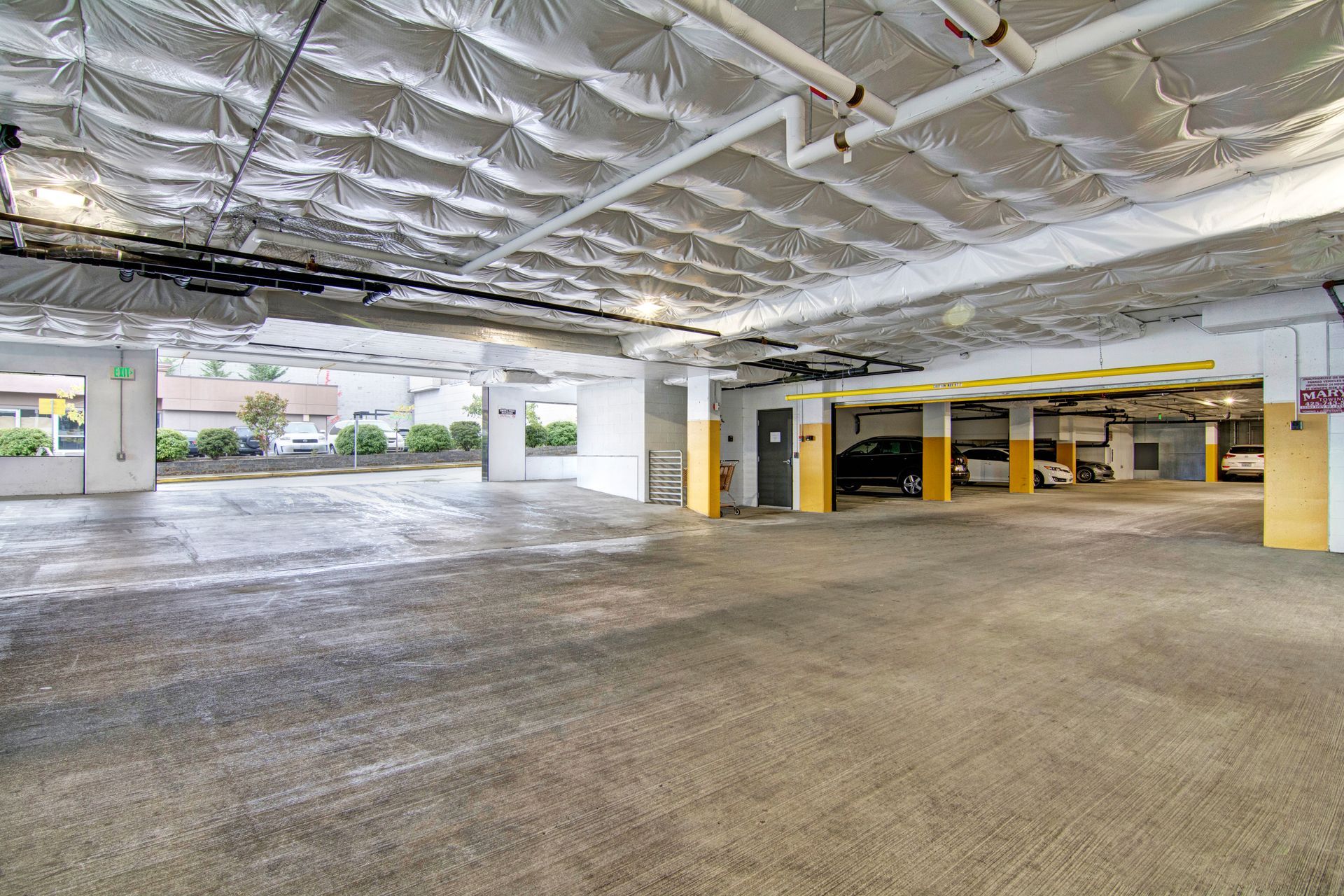 A parking garage with a lot of cars parked in it.