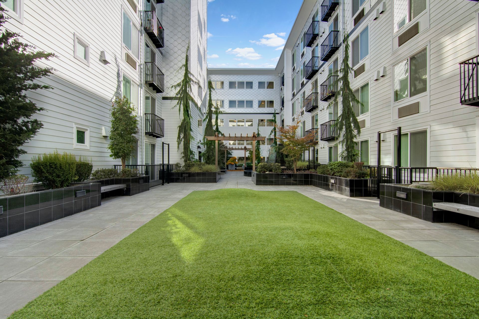 There is a large lawn in the middle of a building.