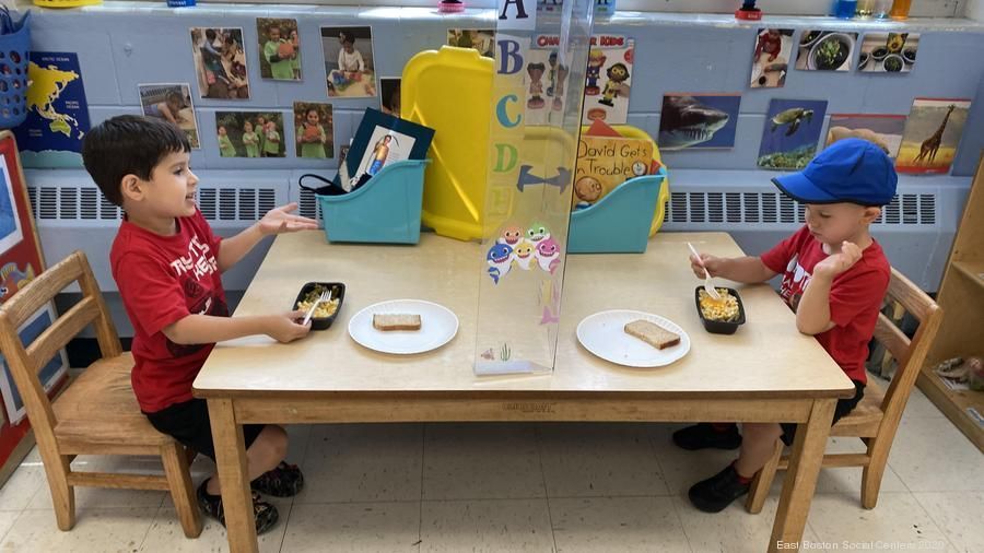 Children take a break with some food in East Boston Social Centers