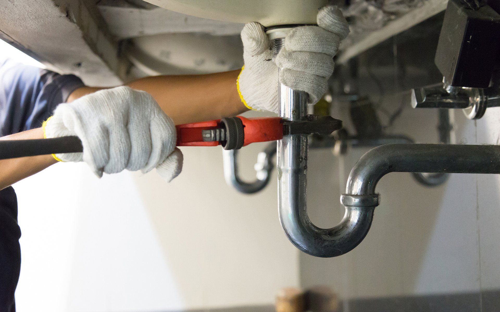 Plumber At Work — Houston, TX — Sandtech – S. T. Construction Corp.