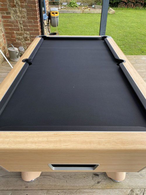black re-clothed pool table