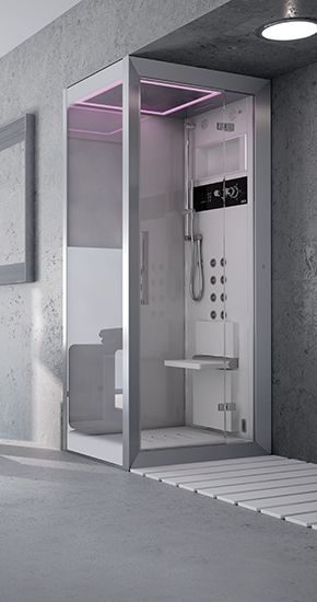 Cabine de douche moderne avec portes en verre, intérieur blanc et siège, dans une salle de bains minimaliste.