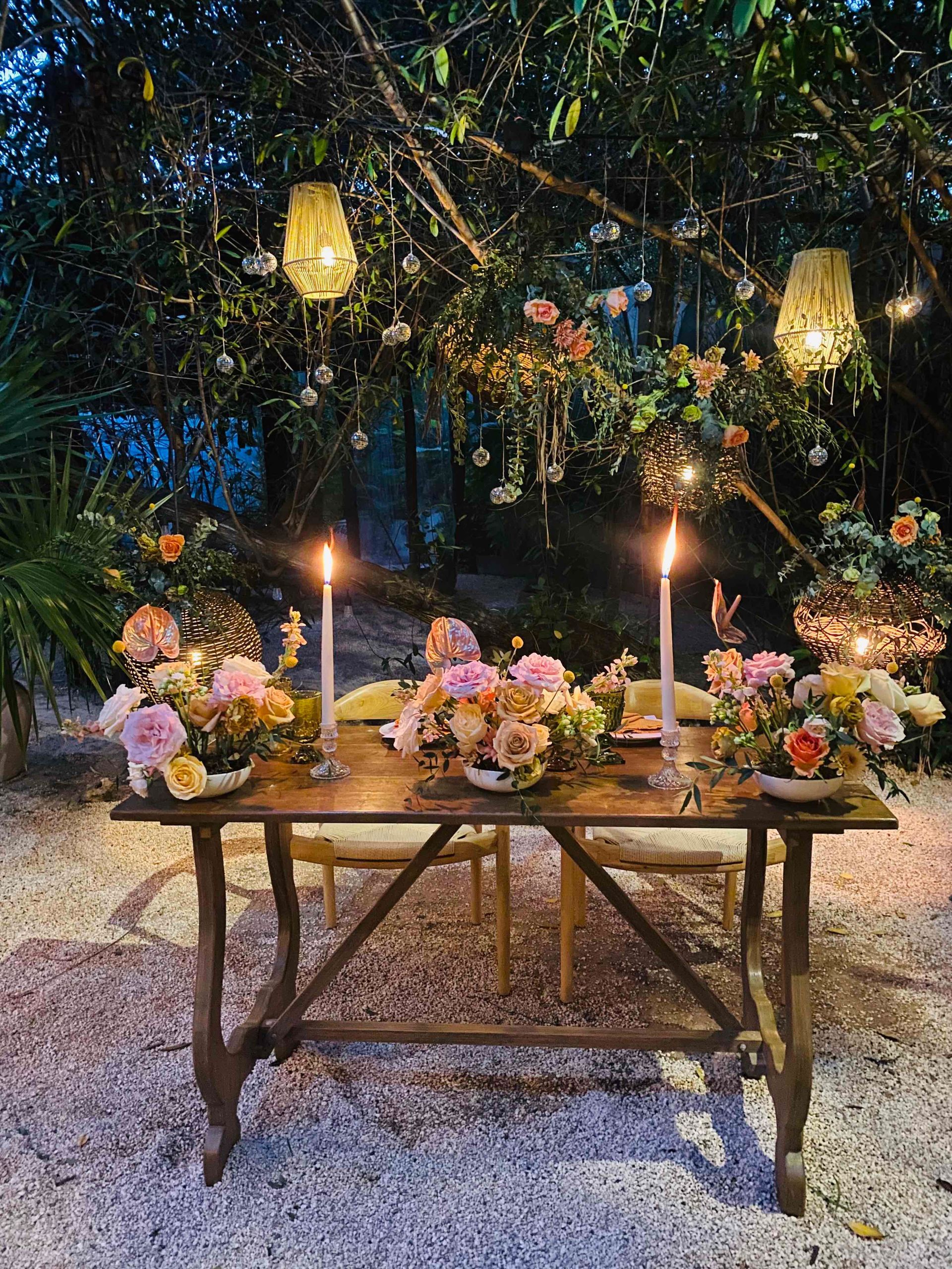 A wooden table with candles and flowers on it
