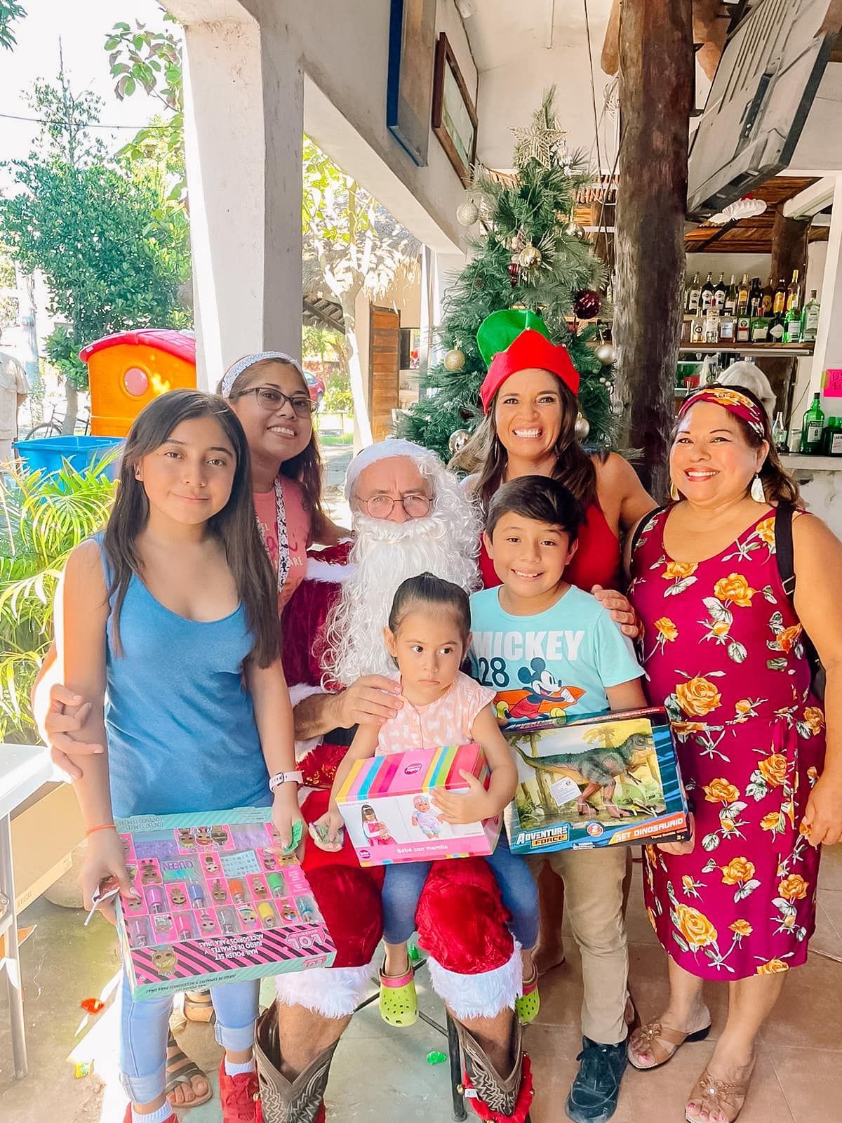 A group of people are posing for a picture with santa claus.
