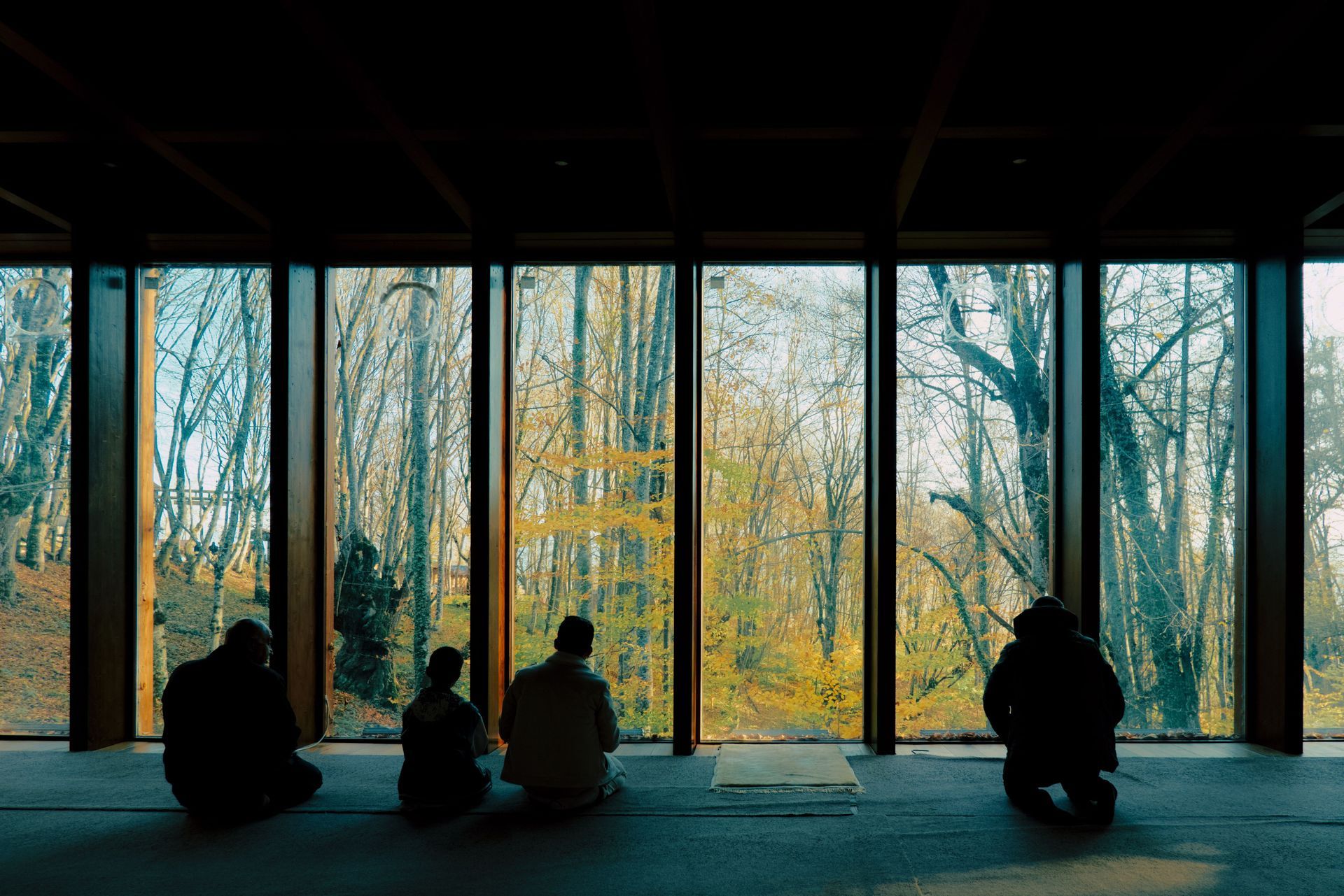 Small group seated in a circle, hands clasped in conversation or support setting