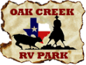Oak Creek RV Park logo: Cowboy on horseback roping a steer in front of Texas flag.