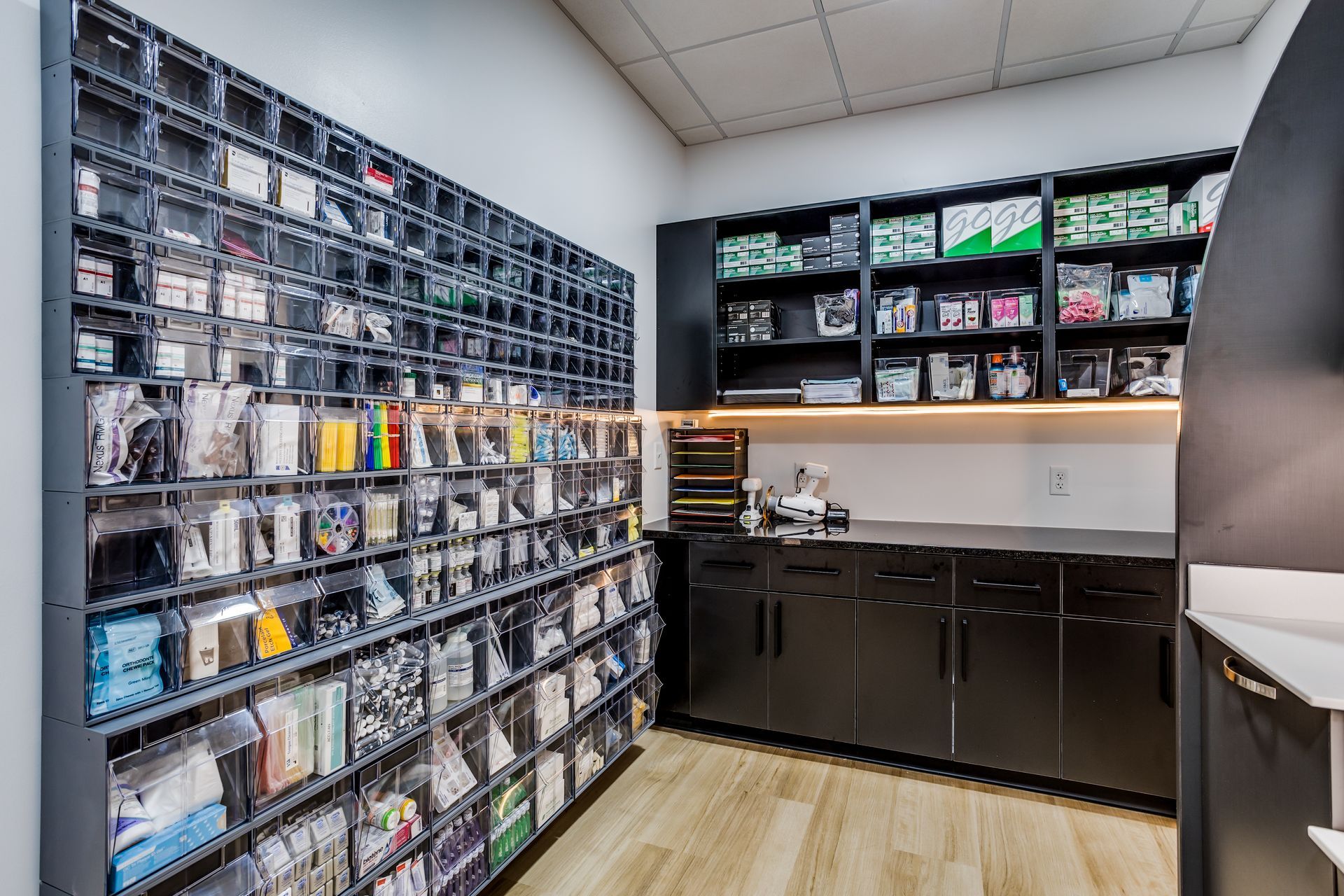 A room with a lot of shelves and cabinets and a counter.
