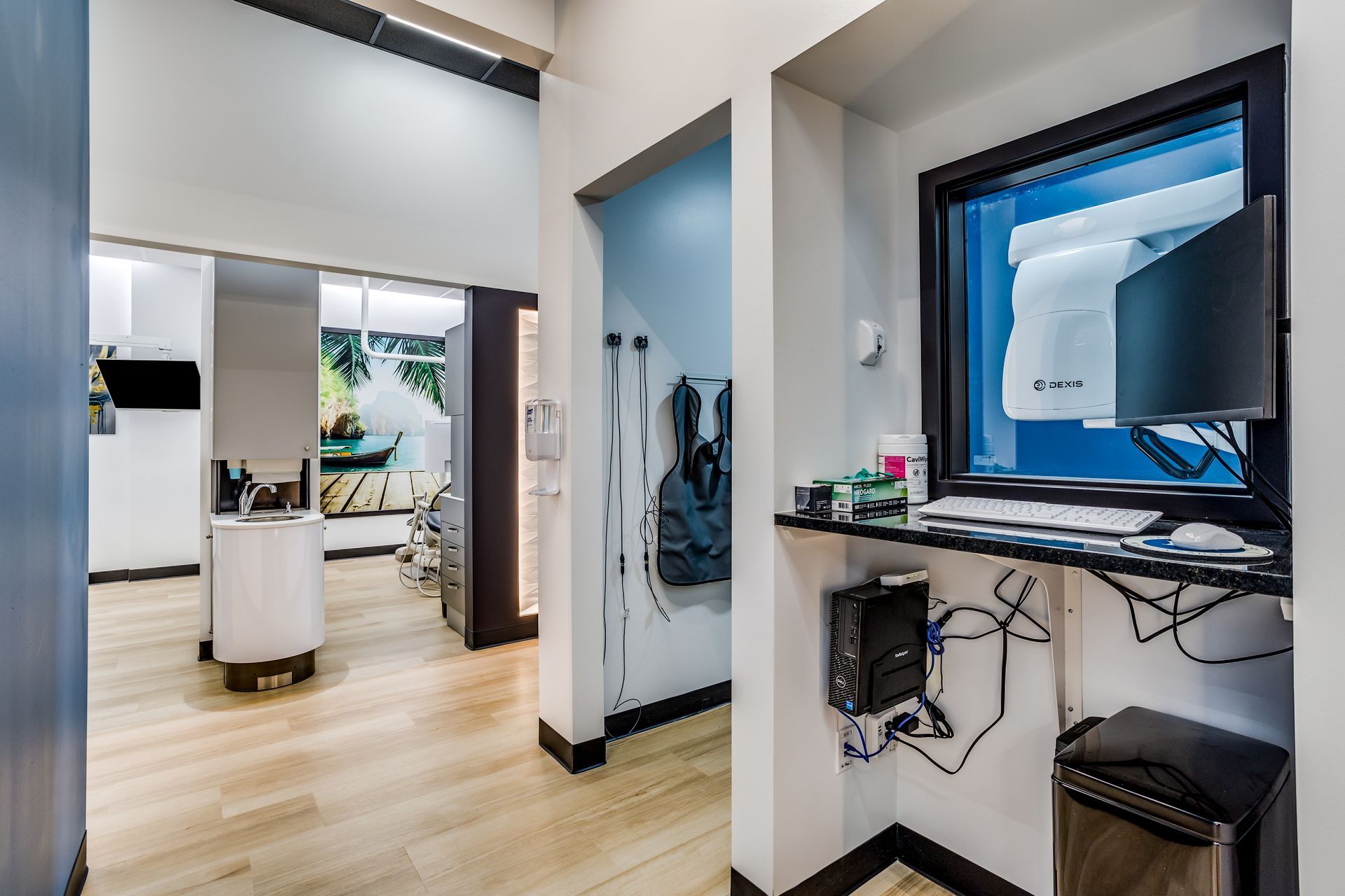 A dental office with a computer desk and a window.