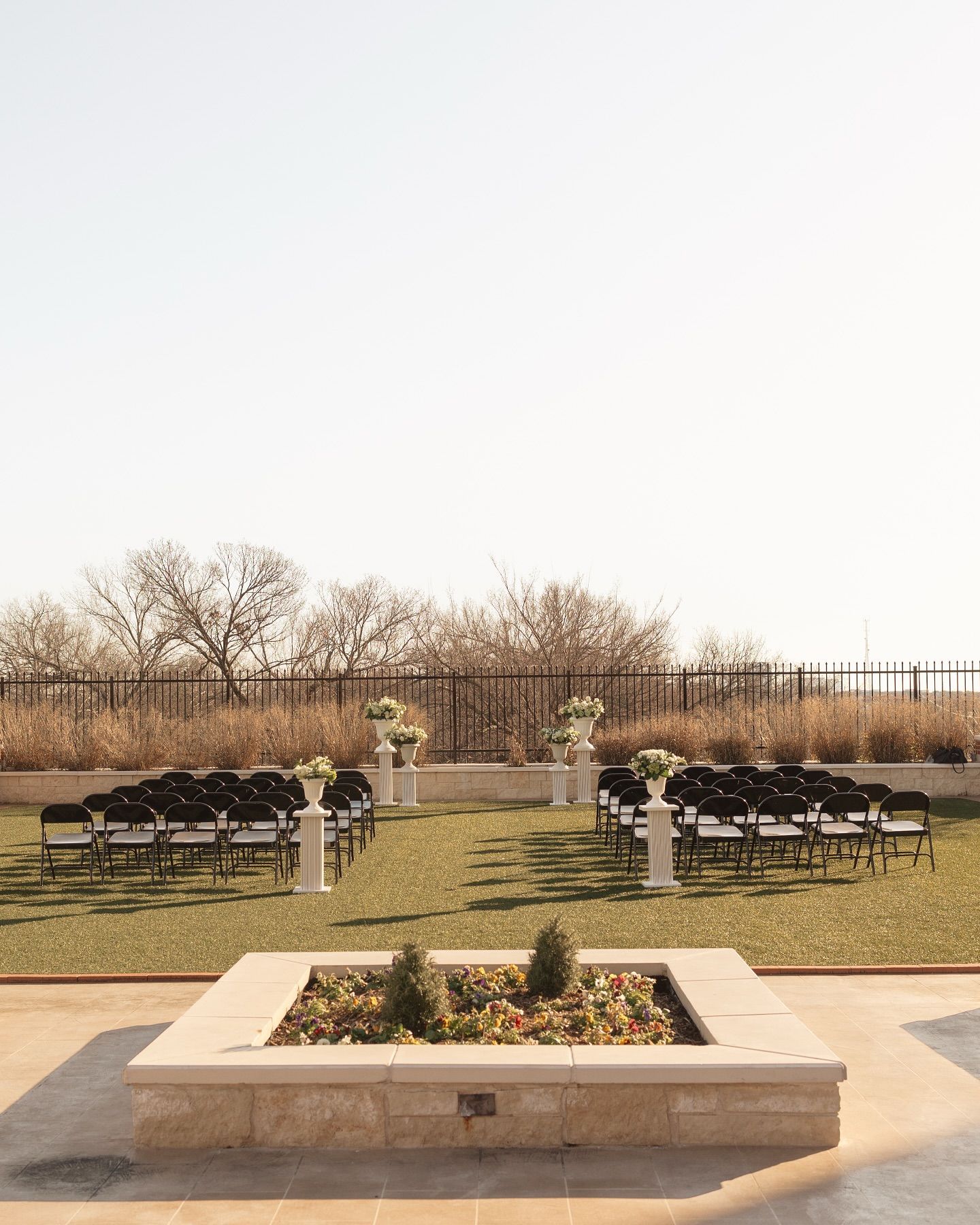 A row of chairs are set up for a wedding ceremony