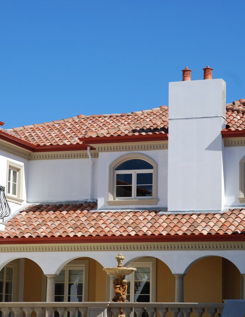 A Large White House With a Red Tiled Roof — High Performance Roof Tiling P/L in Atherton Tablelands, QLD