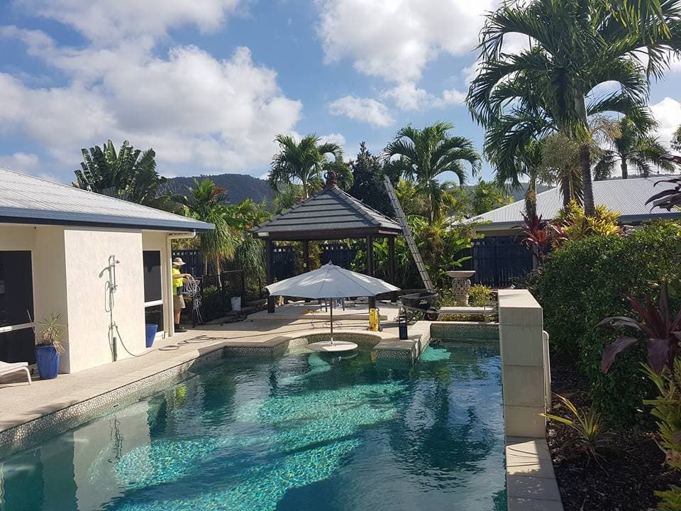 A Large Swimming Pool With a Gazebo in the Background — High Performance Roof Tiling P/L in Tully, QLD