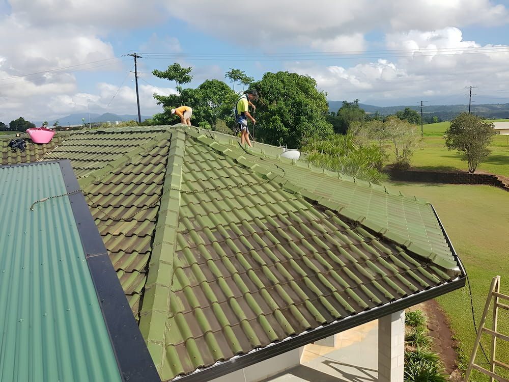 A Group of People Are Working on the Roof of a House — High Performance Roof Tiling P/L in Atherton Tablelands, QLD