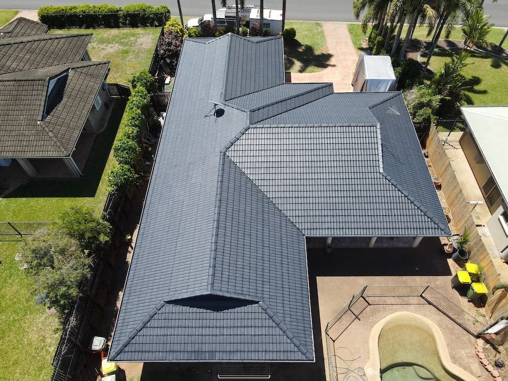 An Aerial View of a House With a Tiled Roof and a Pool — High Performance Roof Tiling P/L in Port Douglas, QLD