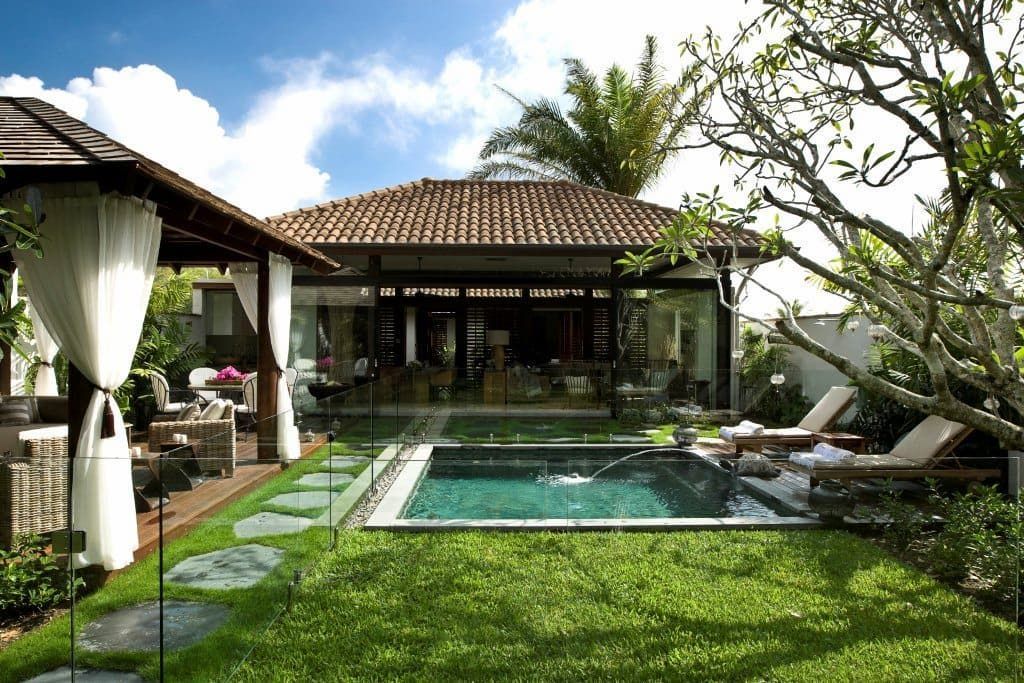 A House With a Large Swimming Pool in Front of It — High Performance Roof Tiling P/L in Mareeba, QLD
