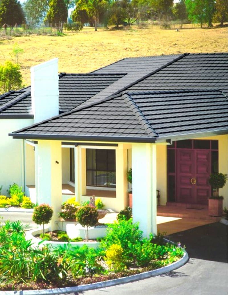A White House With a Black Roof and a Red Door — High Performance Roof Tiling P/L in Port Douglas, QLD