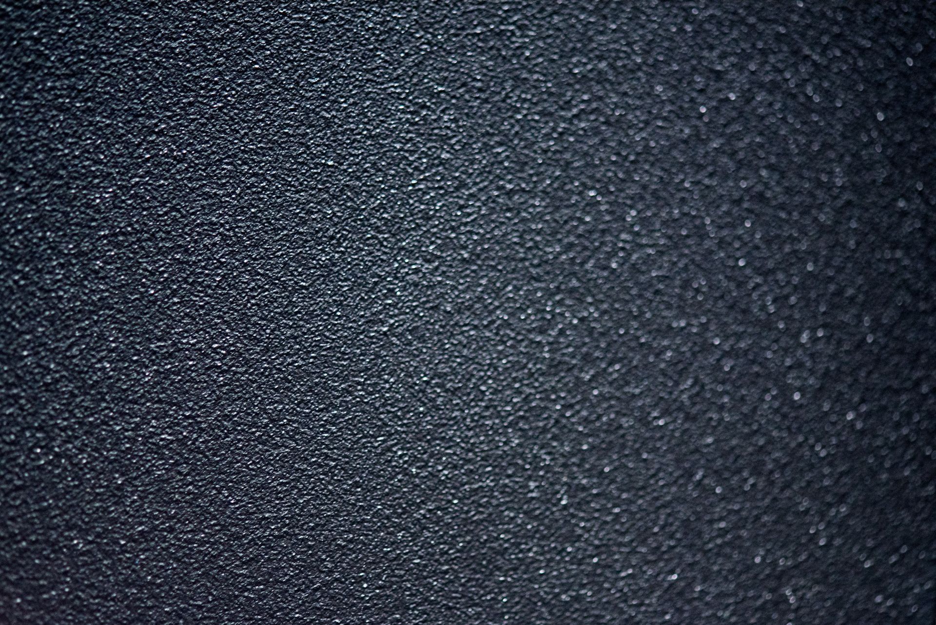 A textured surface of painted metal with powder coating.