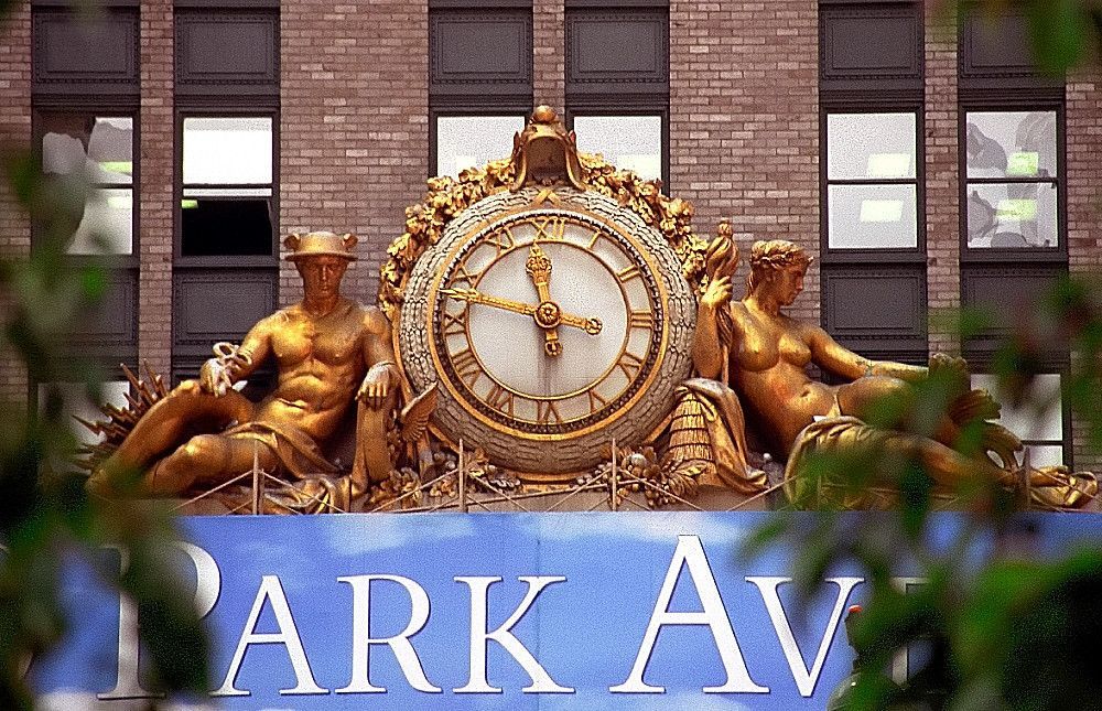 Clock and golden statues atop the Park Avenue building in New York City.