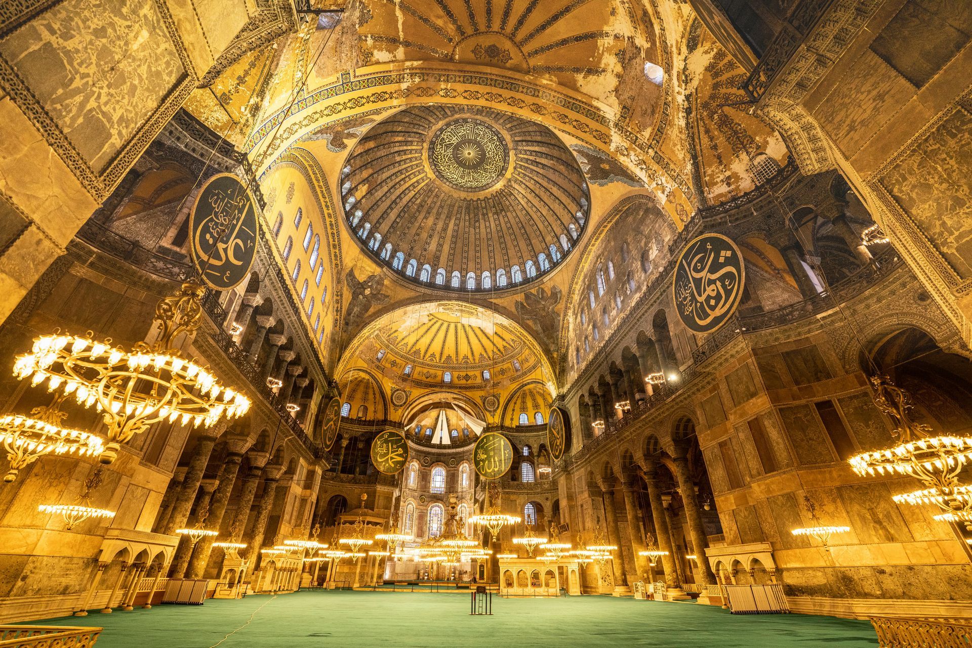 Ornate gold-lit cathedral interior with mosaic domes, arches, and chandeliers
