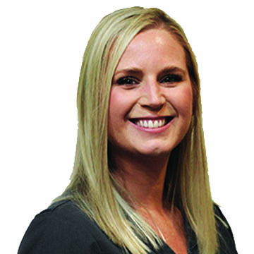 A woman with long blonde hair is smiling for the camera.