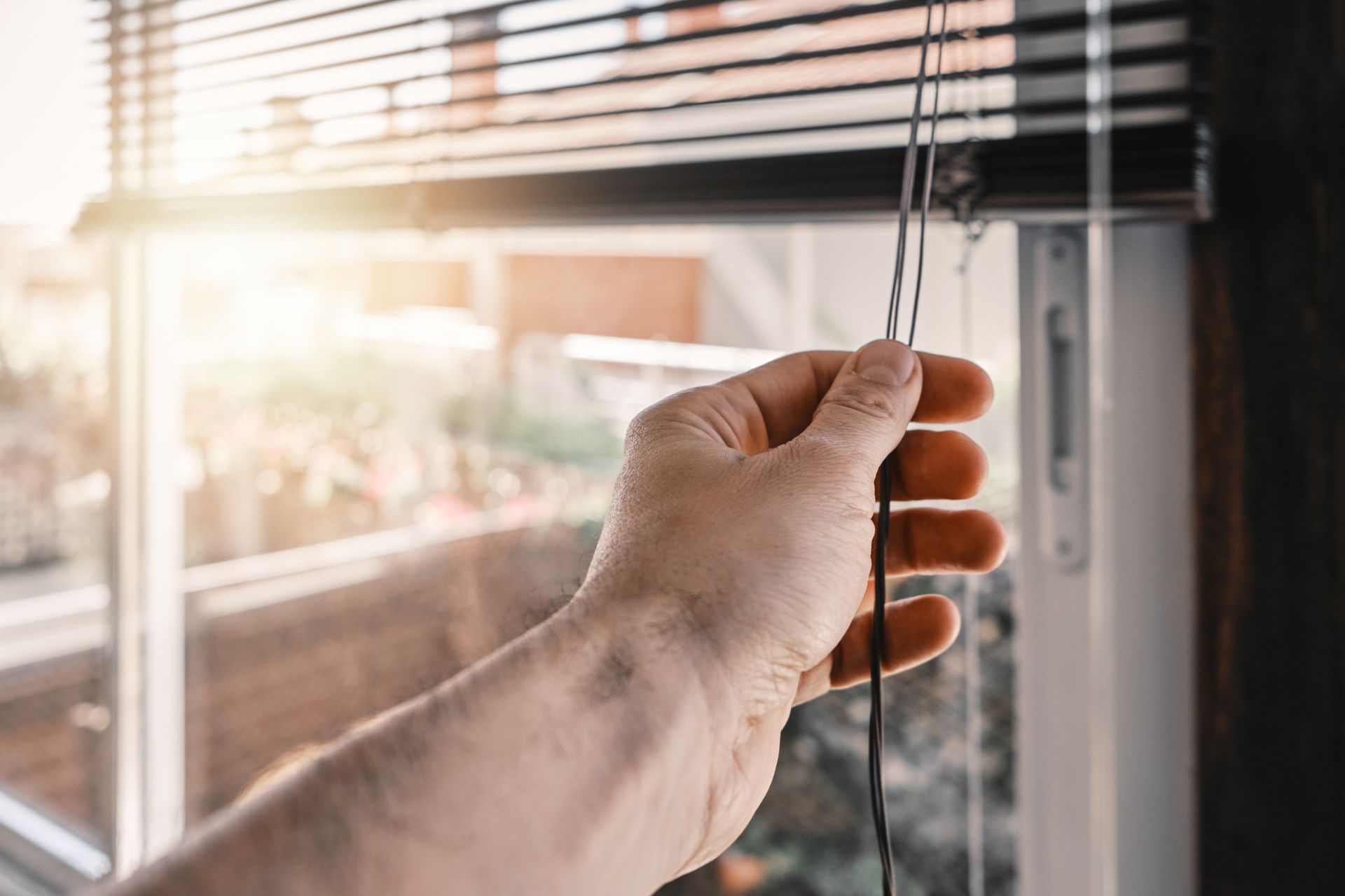 Opening the roller blinds in the morning on sunny day. Opening the roller blinds in the morning on sunny day.