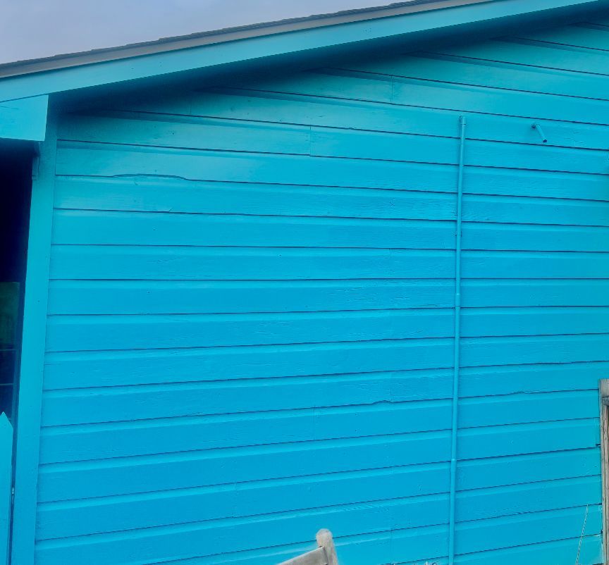 Blue building exterior with horizontal siding.