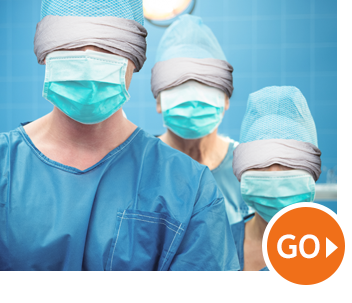 Masked medical staff in blue scrubs and head wraps, with an orange Masked medical staff in blue scrubs and head wraps, with an orange