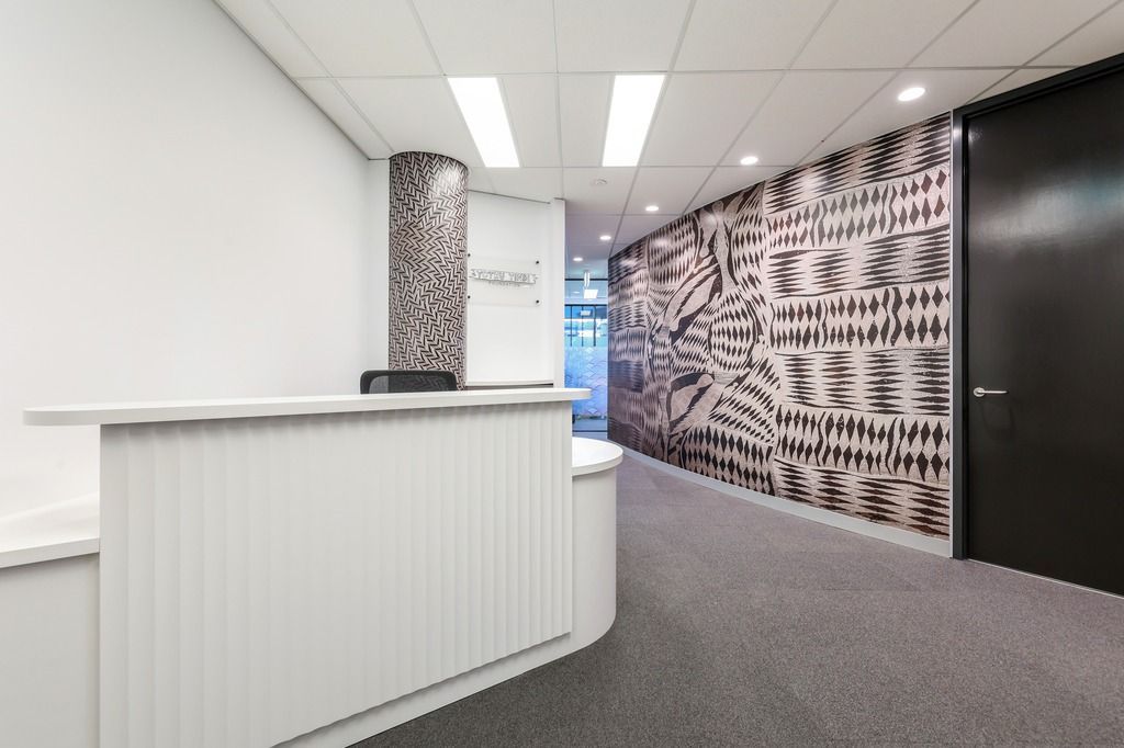 A White Reception Desk in An Office Hallway — Invision NT in Katherine, NT