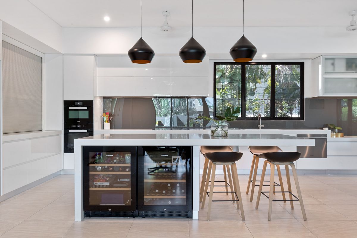 A Modern Kitchen with Stools and Wine Fridge — Invision NT in Coconut Grove, NT