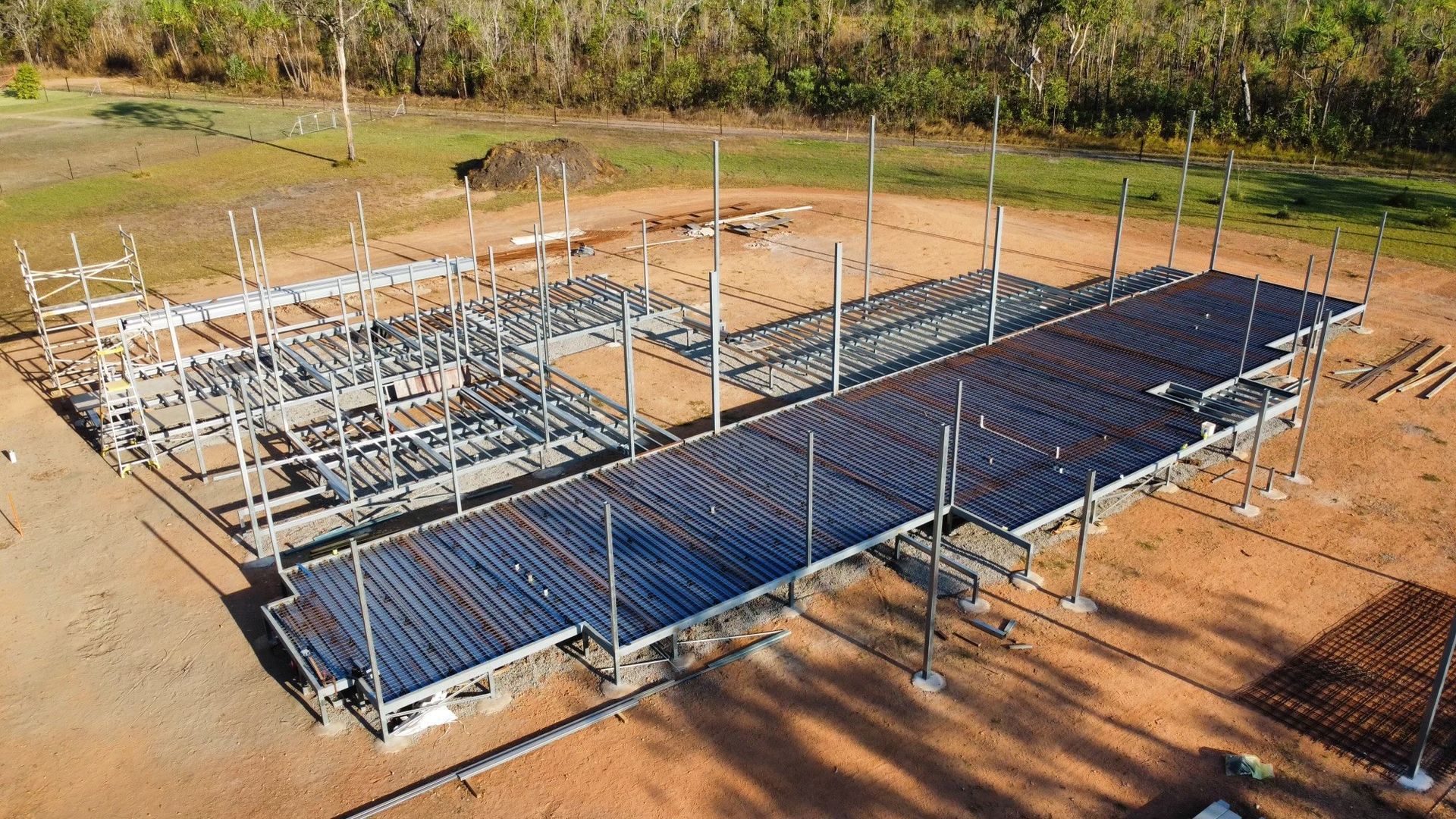 A Construction Site with Steel Framework and Concrete Base — Invision NT in Coconut Grove, NT