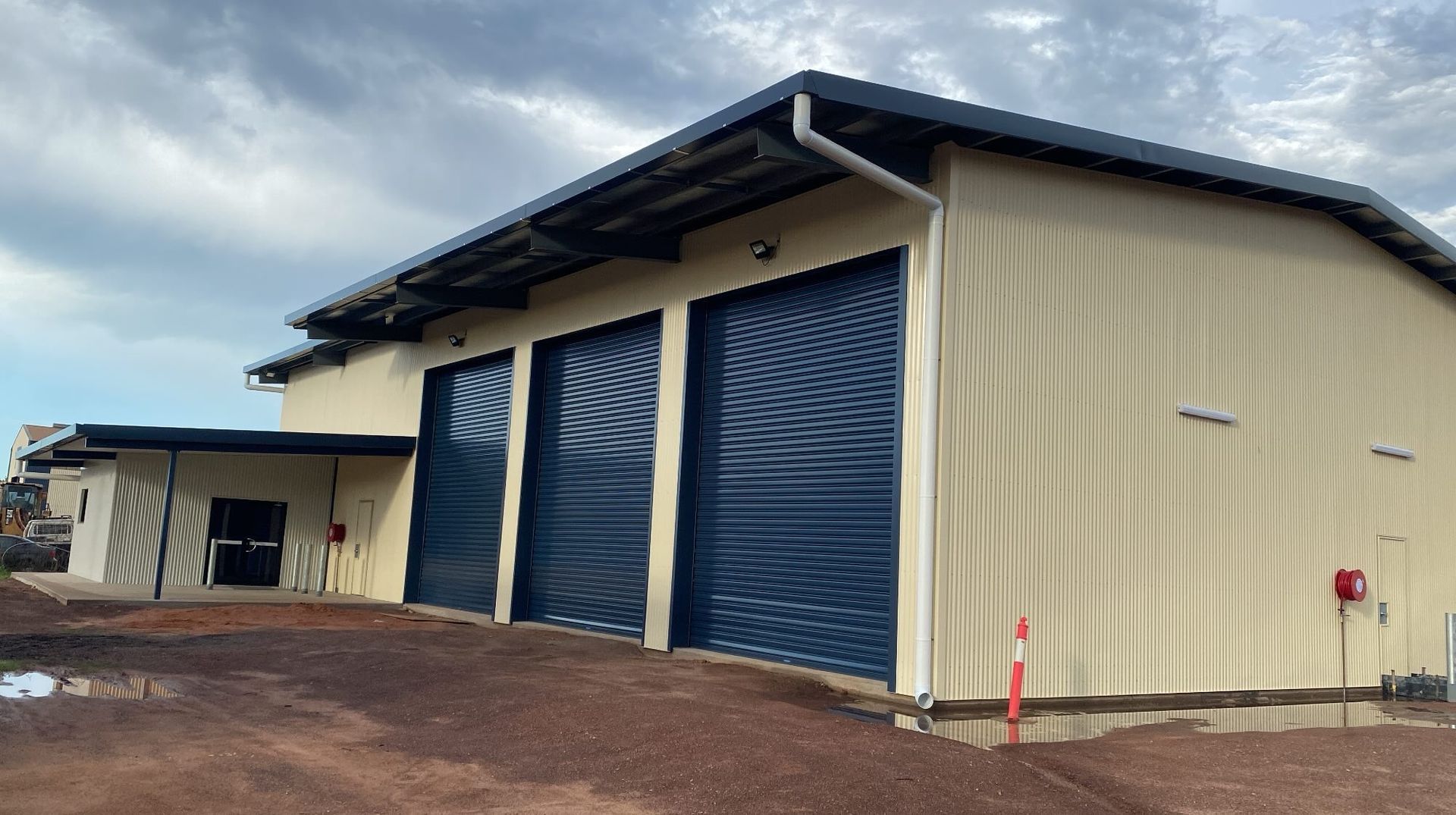 An Industrial Building with Three Large Doors — Invision NT in Coconut Grove, NT