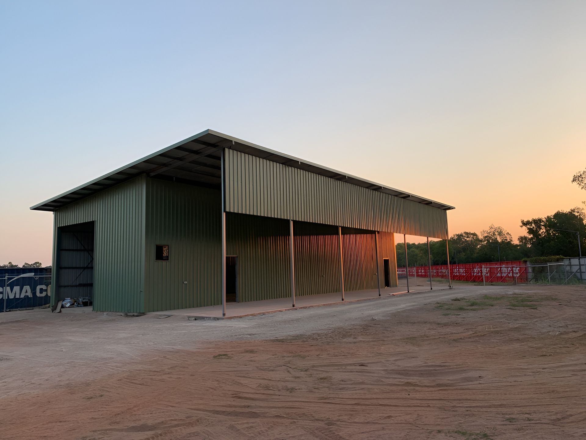 A Green Metal Shed at Sunset — Invision NT in Coconut Grove, NT