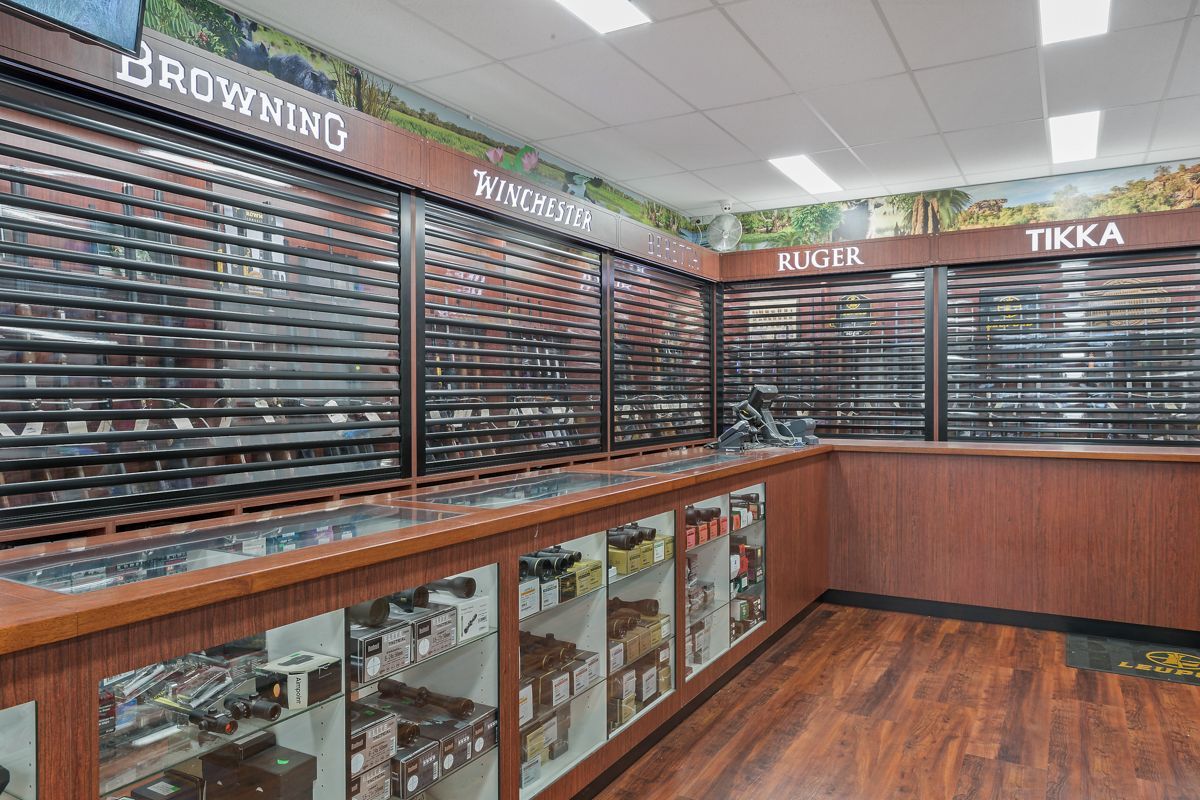An Interior of A Gun Store with Display Cases — Invision NT in Coconut Grove, NT