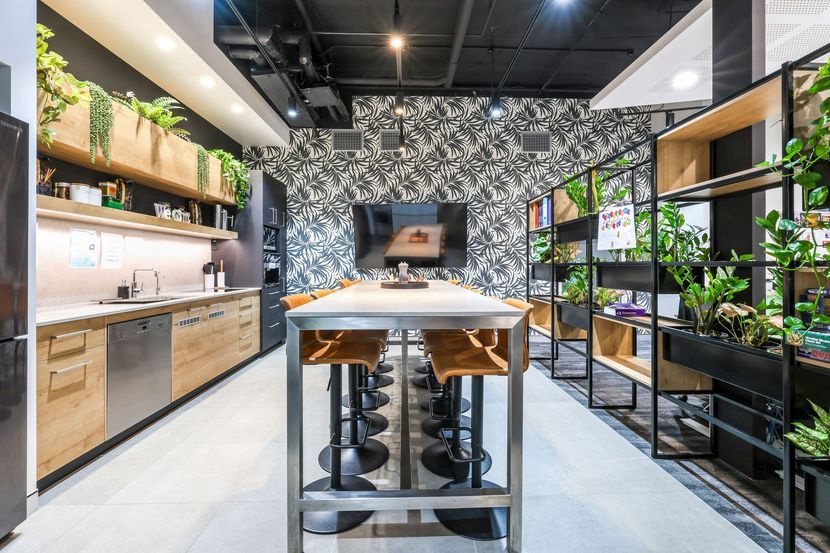 Modern kitchen showroom with black-and-wood island, open shelves, and potted plants — Invision NT in Gove, NT