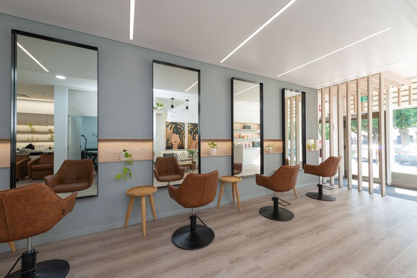 Modern salon interior with styling chairs, mirrors, and light wood floors — Invision NT in Gove, NT